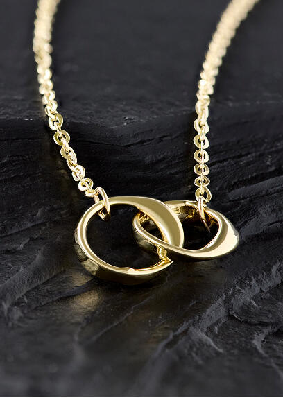A yellow gold necklace featuring two interlocking rings