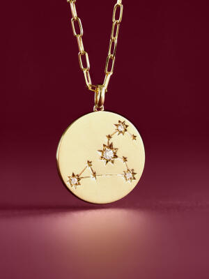 A yellow gold pendant necklace with Ikuma diamonds representing a Zodiac sign.