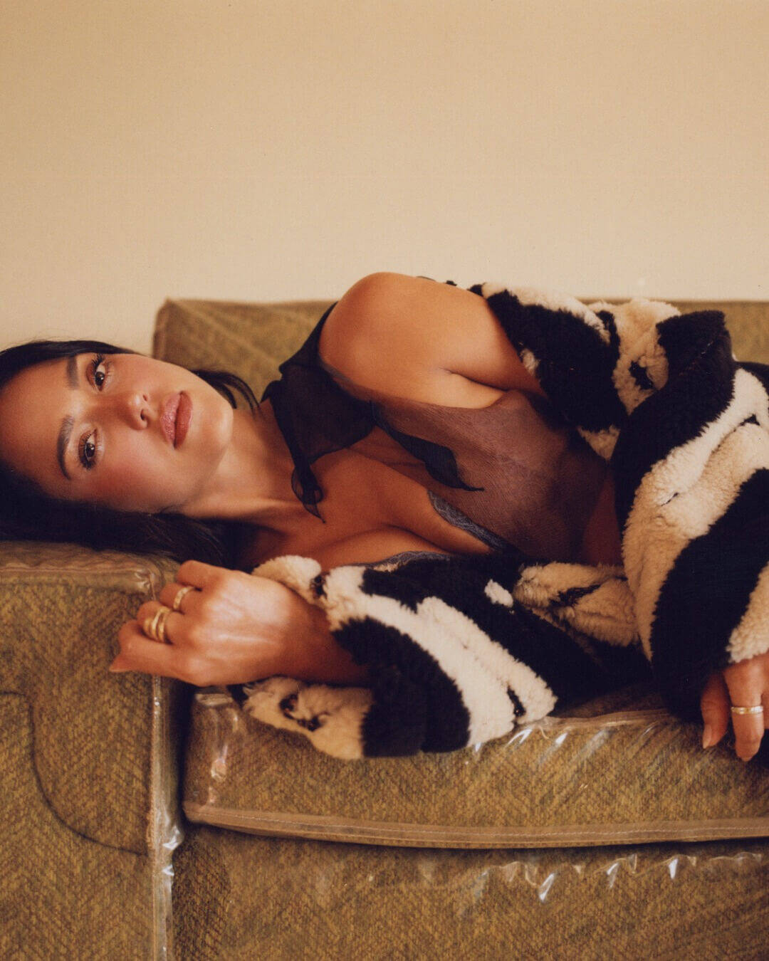 Jessica Alba wearing stacked gold Ben Bridge rings, Stella McCartney coat and a Fendi dress.