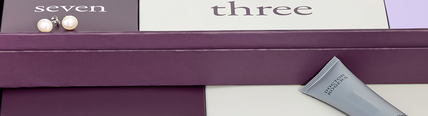 A partial view of the Ben Bridge advent calendar with a pair of pearl studs resting atop the box for day seven.