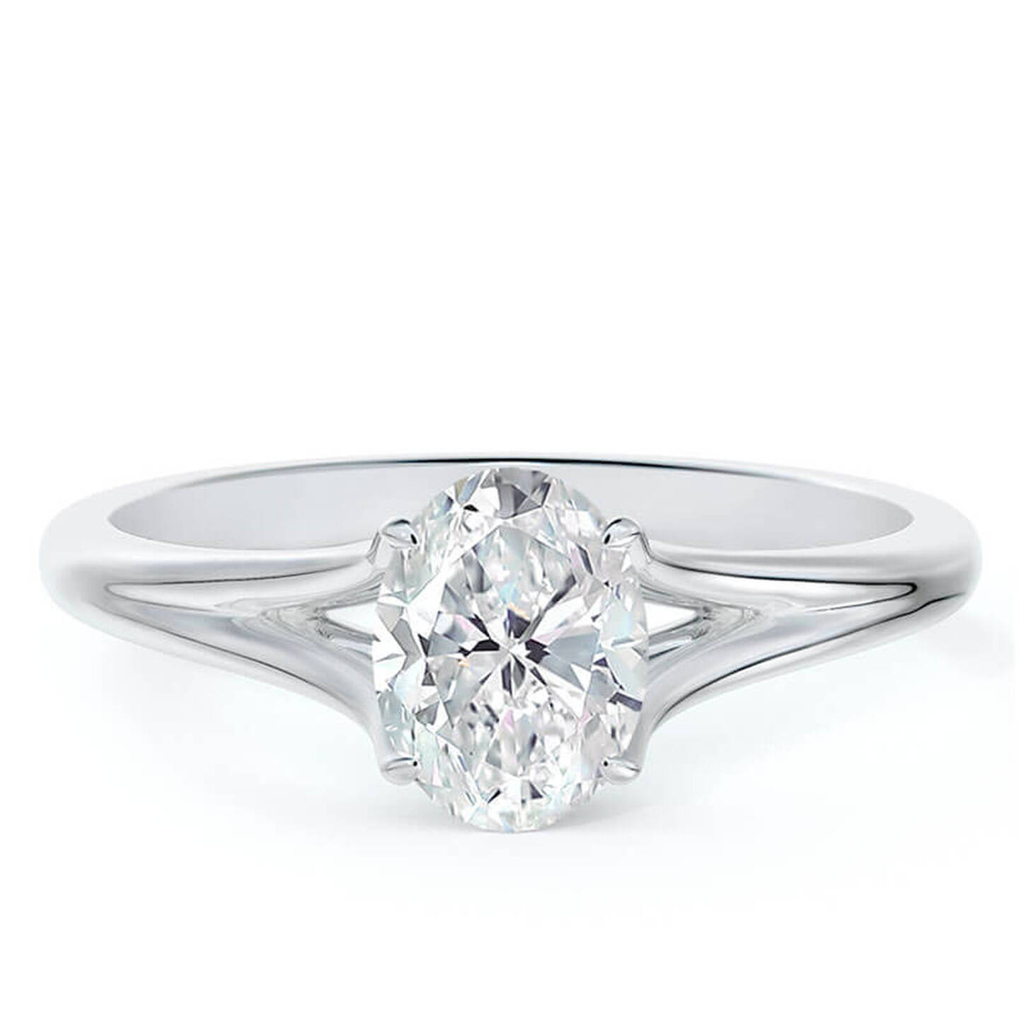 An oval diamond solitaire ring in white gold on a white surface