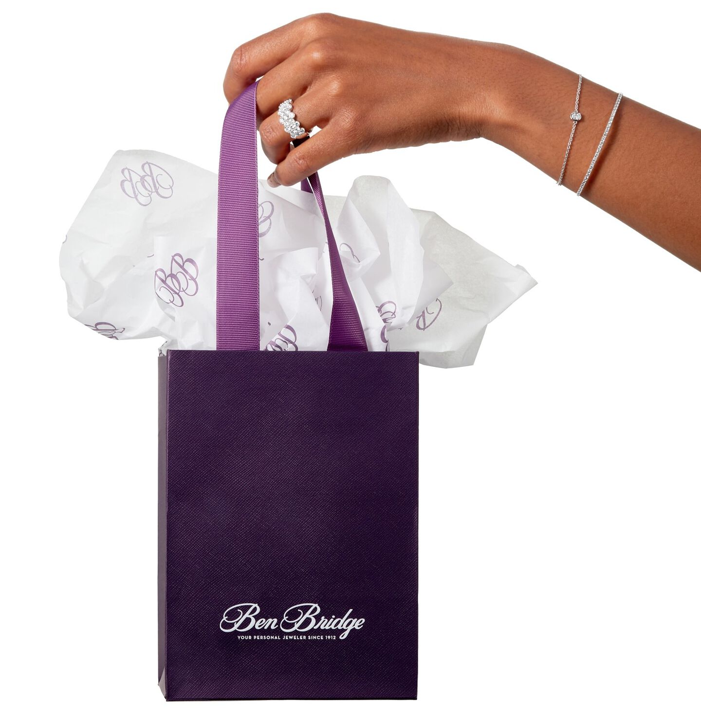 hand holding purple Ben Bridge gift bag