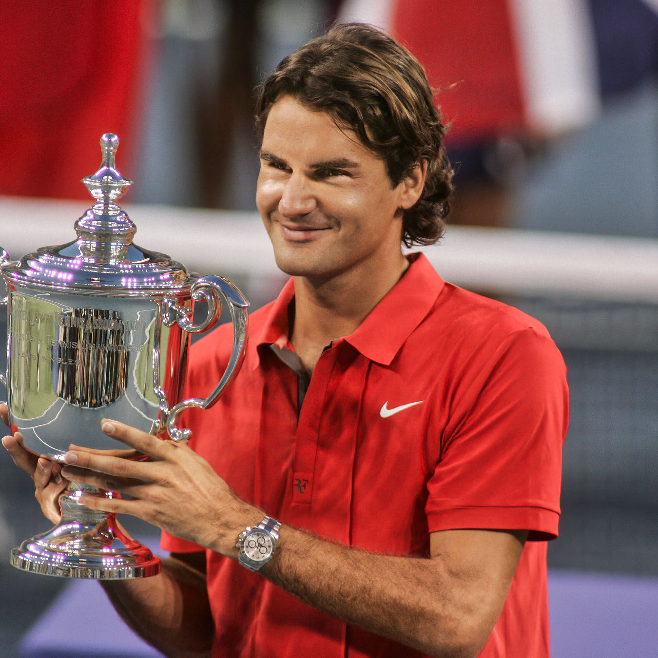 World-renowned tennis player holds his trophy at the US Open.