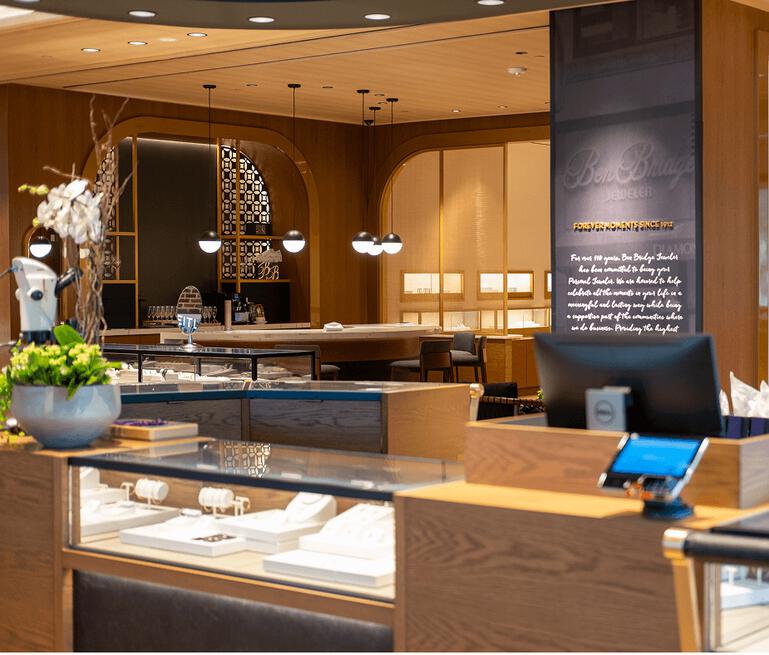 Interior on Ben Bridge jewelry store with display cases and soft, warm lighting