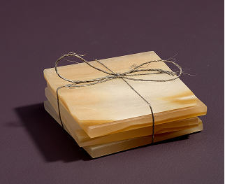 A stack of onyx coasters is tied together with a bit of rustic string