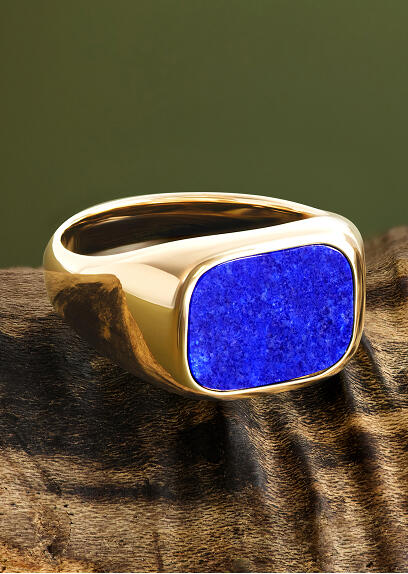 A bold signet ring with a blue gemstone set in yellow gold.