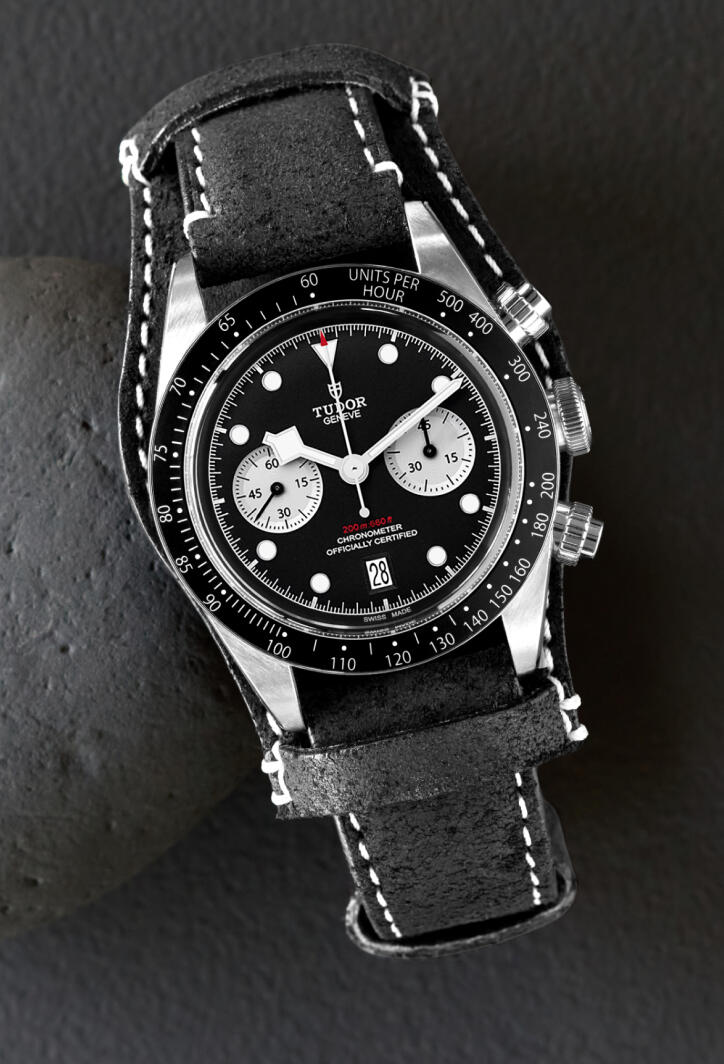 Tudor chronograph watch with a black dial and black leather strap.