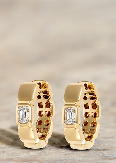 Classic yellow gold hoop earrings with emerald cut diamonds.