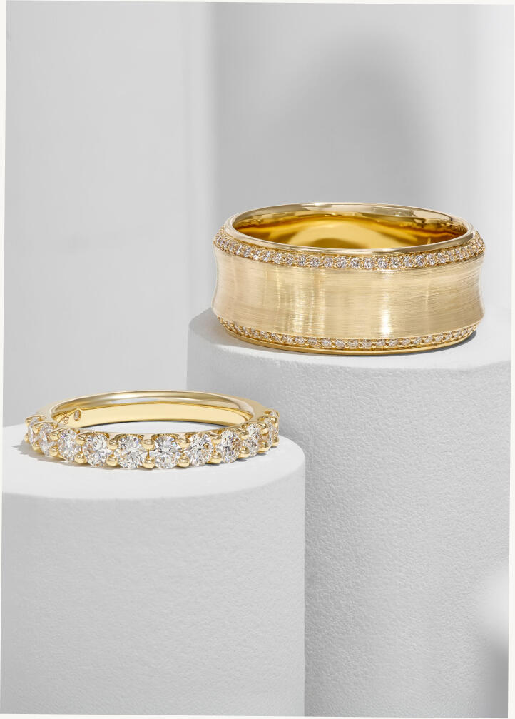Diamond wedding bands in yellow gold, both featuring natural round diamonds. 