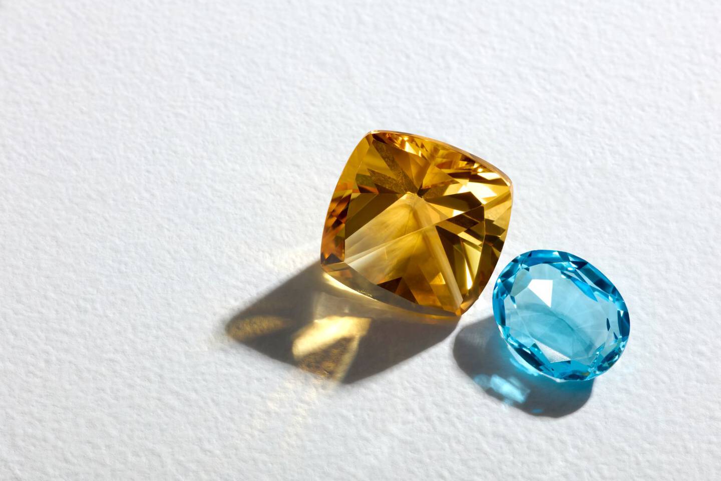 Loose citrine and blue topaz gemstones. 