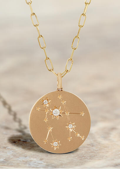Yellow gold pendant with diamonds featuring a zodiac symbol.