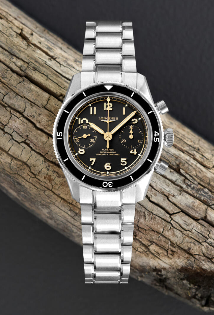 A Longines sport swatch in stainless steel with a black dial and cream hands and numerals.