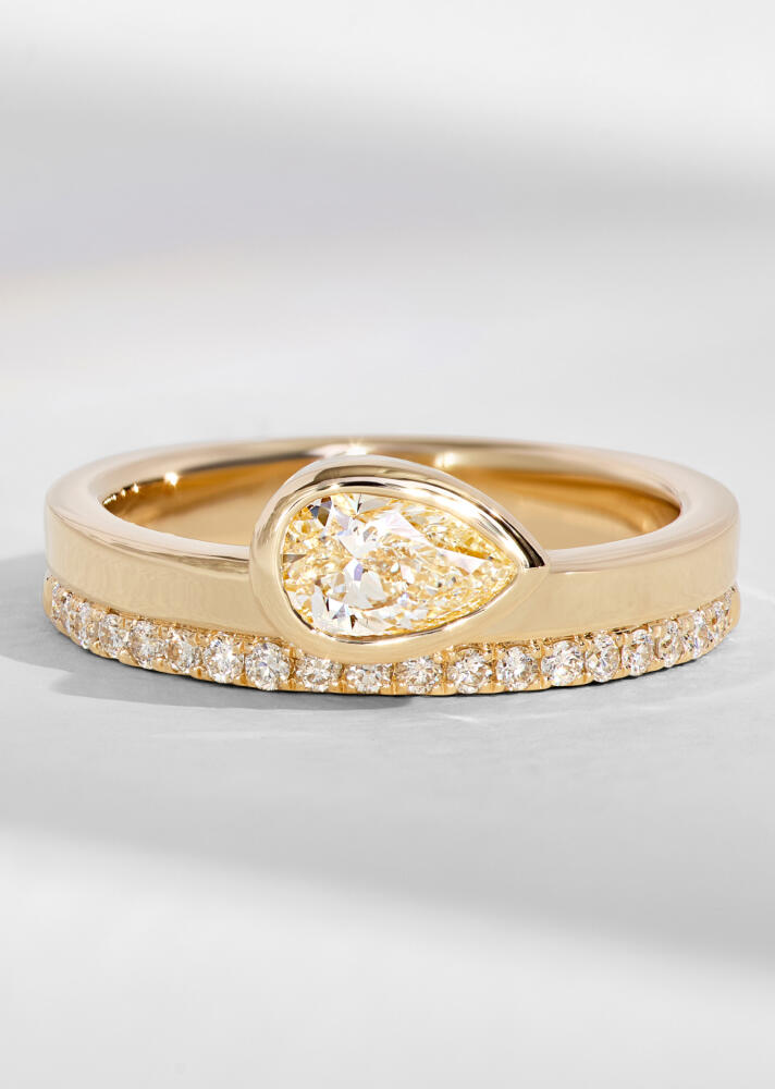 A pear-shaped diamond engagement ring with the diamond in a bezel setting. 