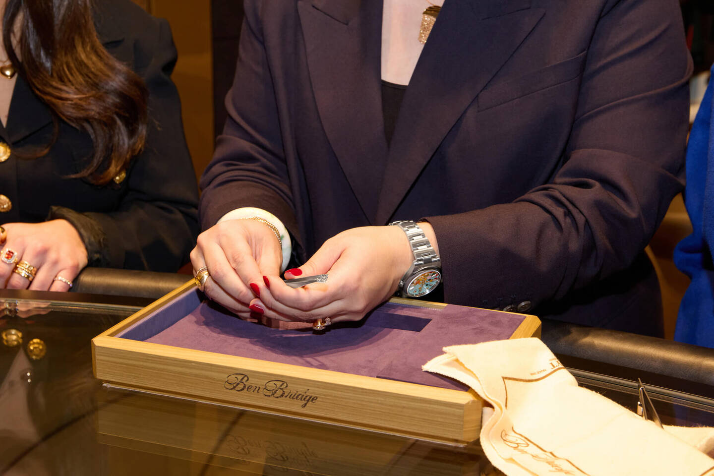 Closeup of people inspecting a loose diamond