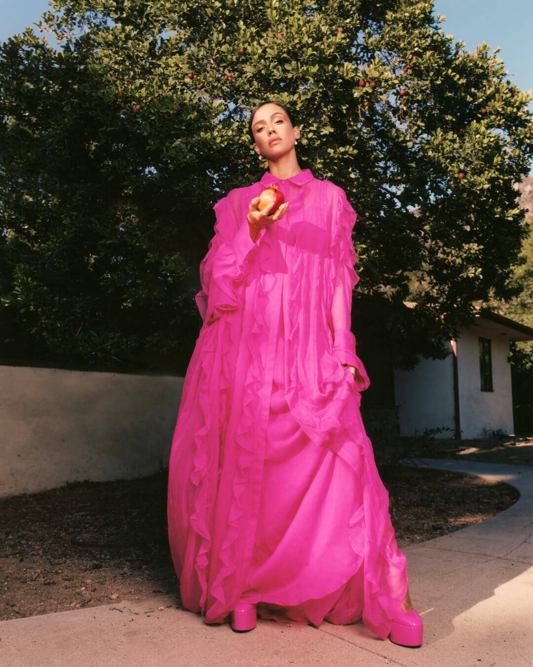 Jessica Alba in pink Valentino dress with matching shirt and shoes with a pair of Ben Bridge pearl earrings and diamond rings.