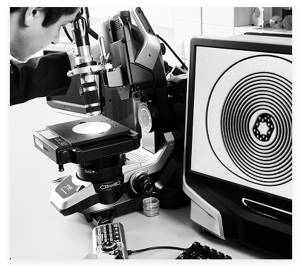 Watchmaker inspecting watch part