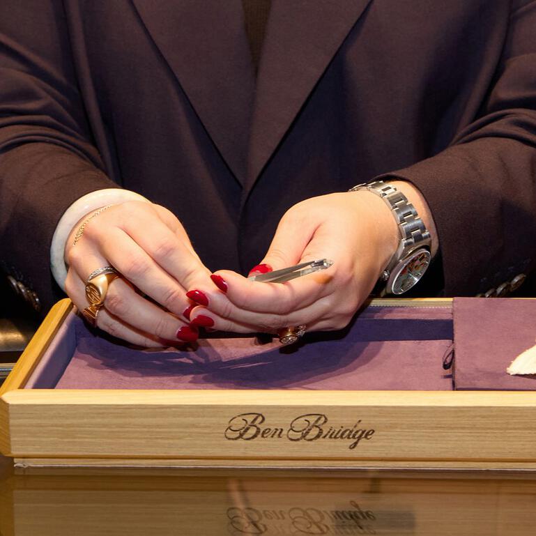 Closeup of hands inspecting gemstones