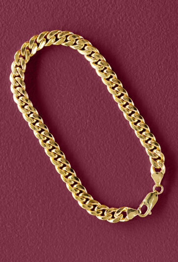 Oris dive watch with purple dial rests on a bed of evergreen needles.