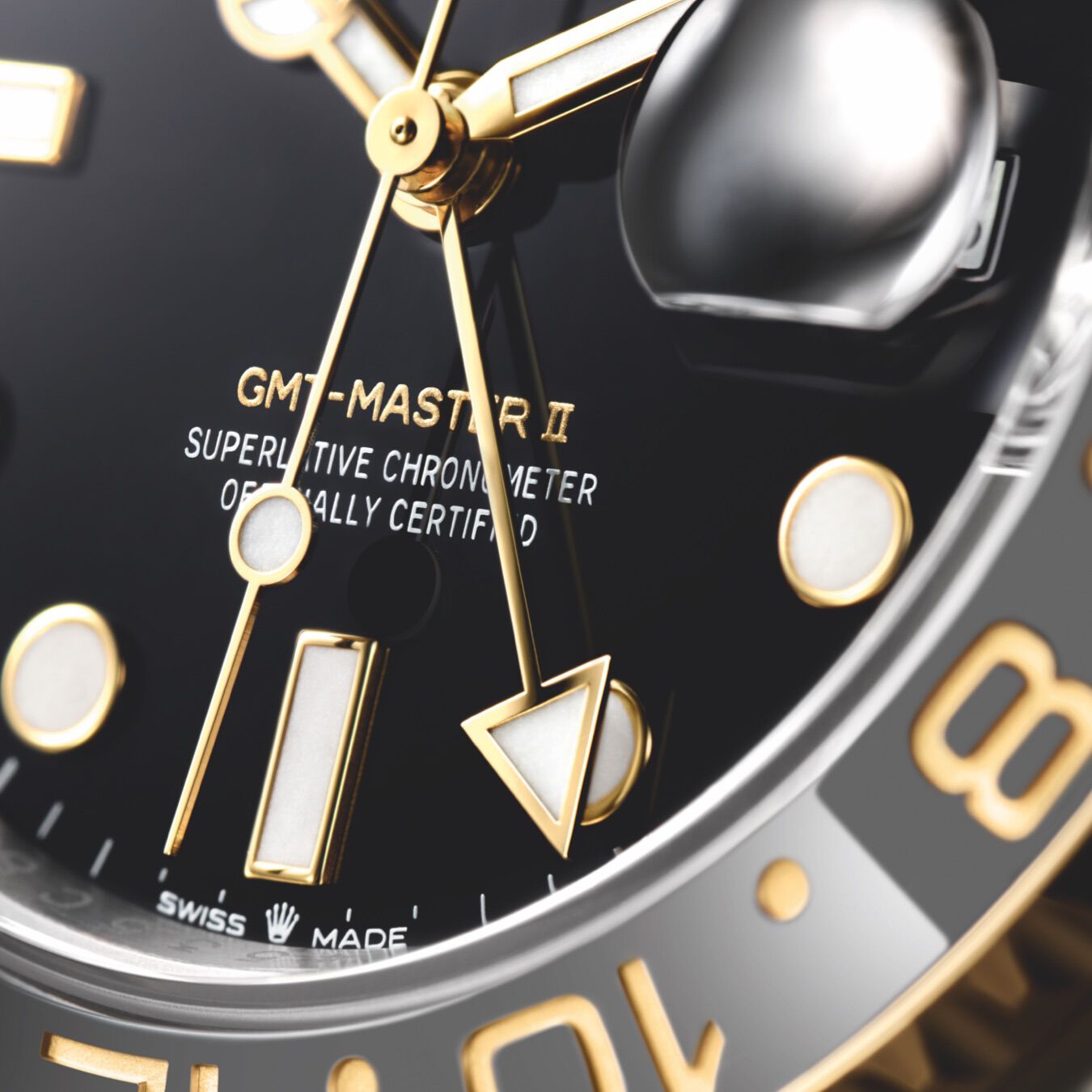 A GMT-Master II black dial with yellow gold hands and luminous indices and cyclops date window. 
