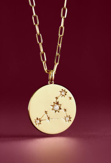 A yellow gold pendant necklace with Ikuma diamonds representing a Zodiac sign.