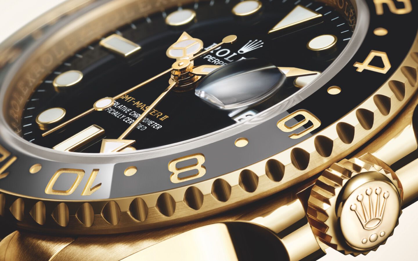 Close-up of Rolex GMT-Master II in yellow gold with a black dial and cyclops date window. 