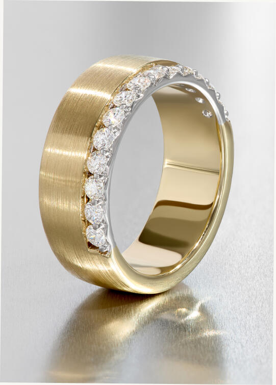 A wedding band in yellow gold with flush set round diamonds on the edge.
