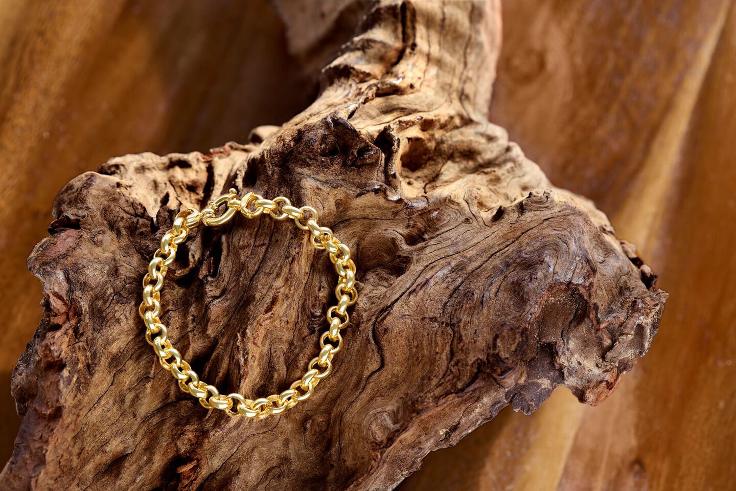 Yellow gold rope chain shines in the palm of someone's hand