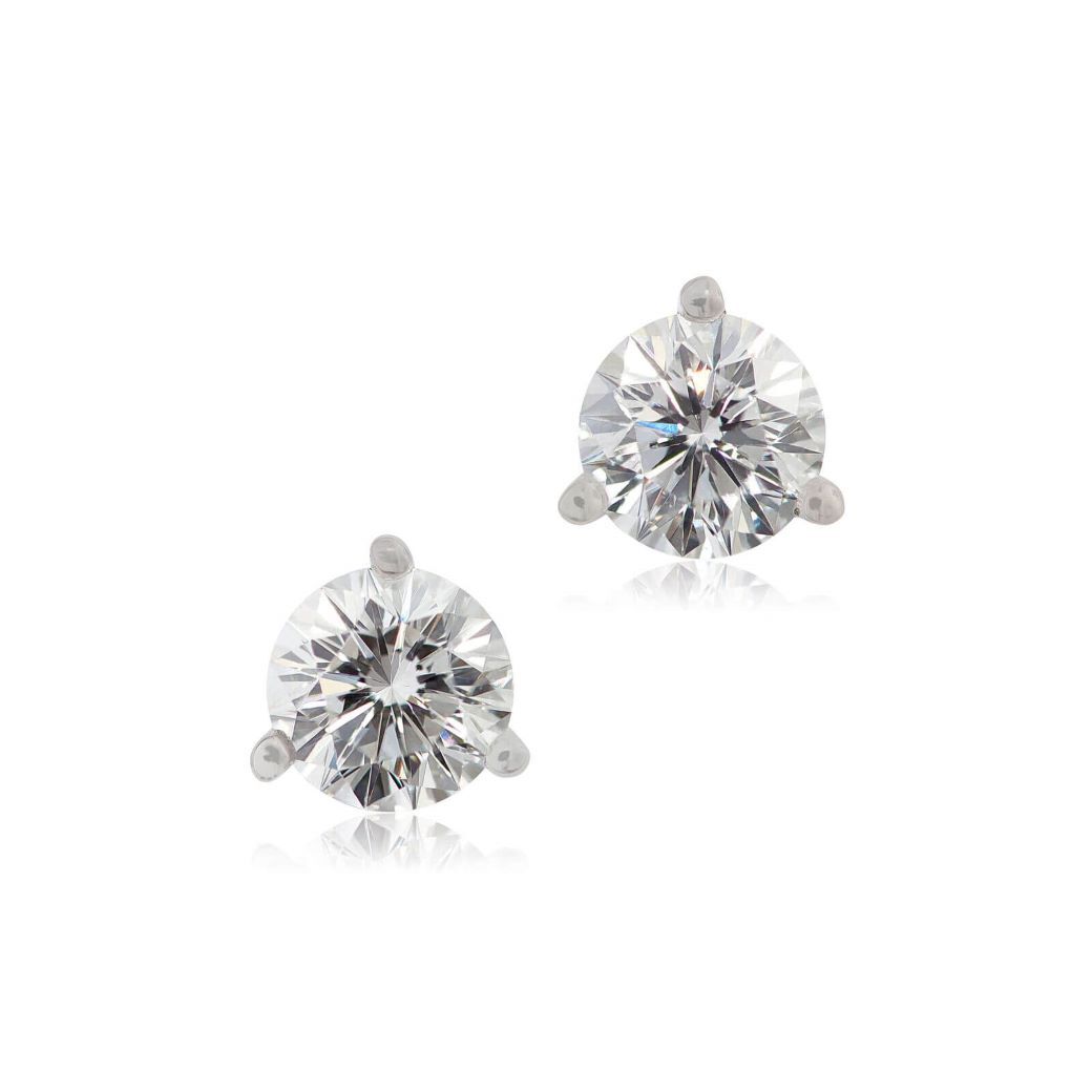 diamond studs with three-prong setting sparkle against a white background