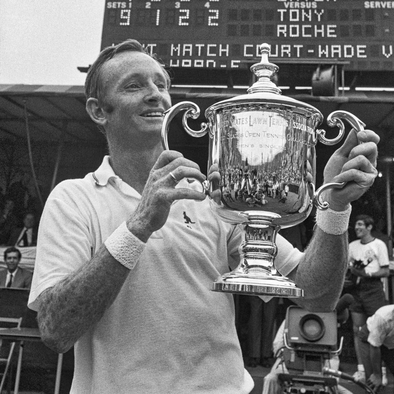 In the mid-20th Century, a player holds up his trophy celebrating his US Open victory.