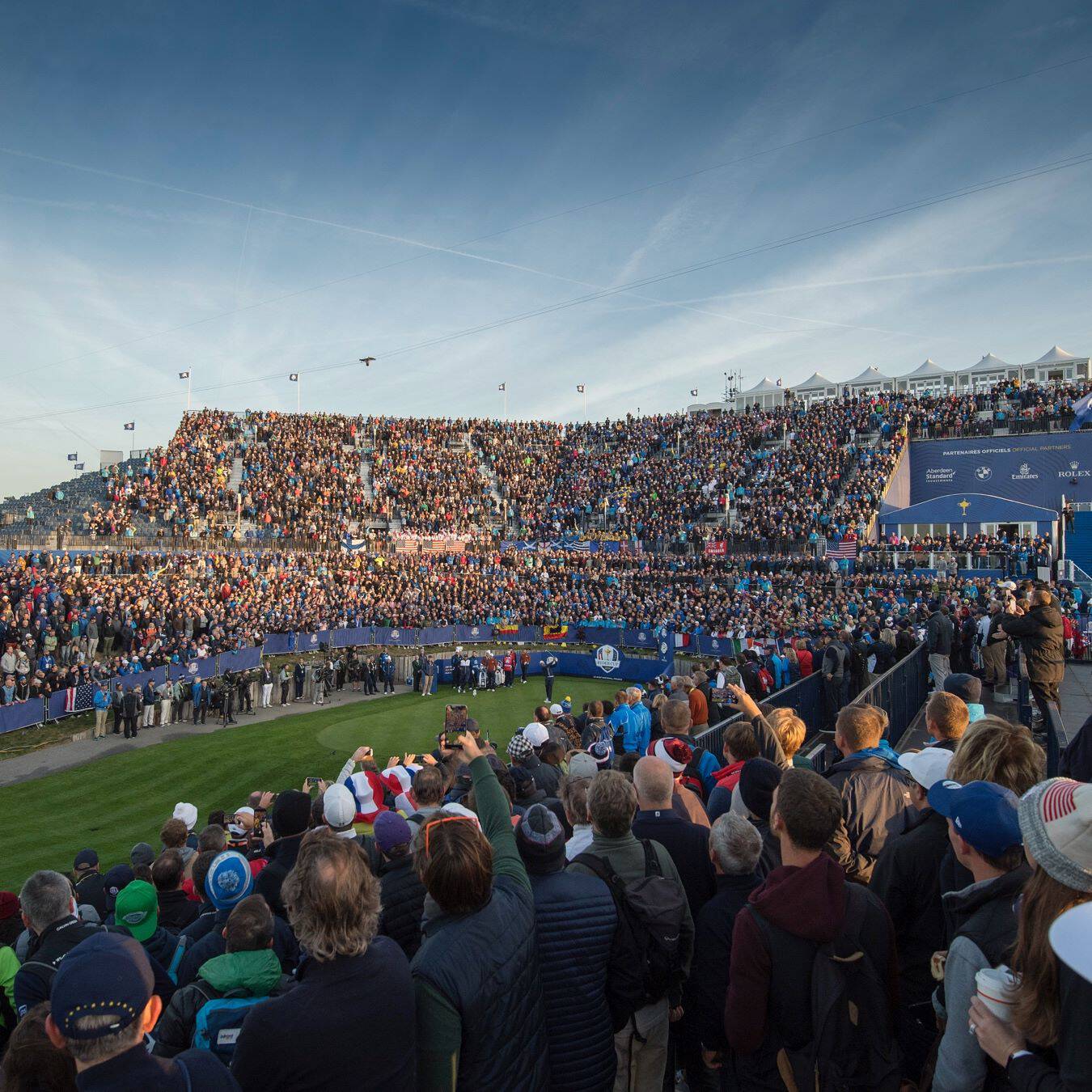 Crowds gather around the green at the Ryder Cup golf tournament.