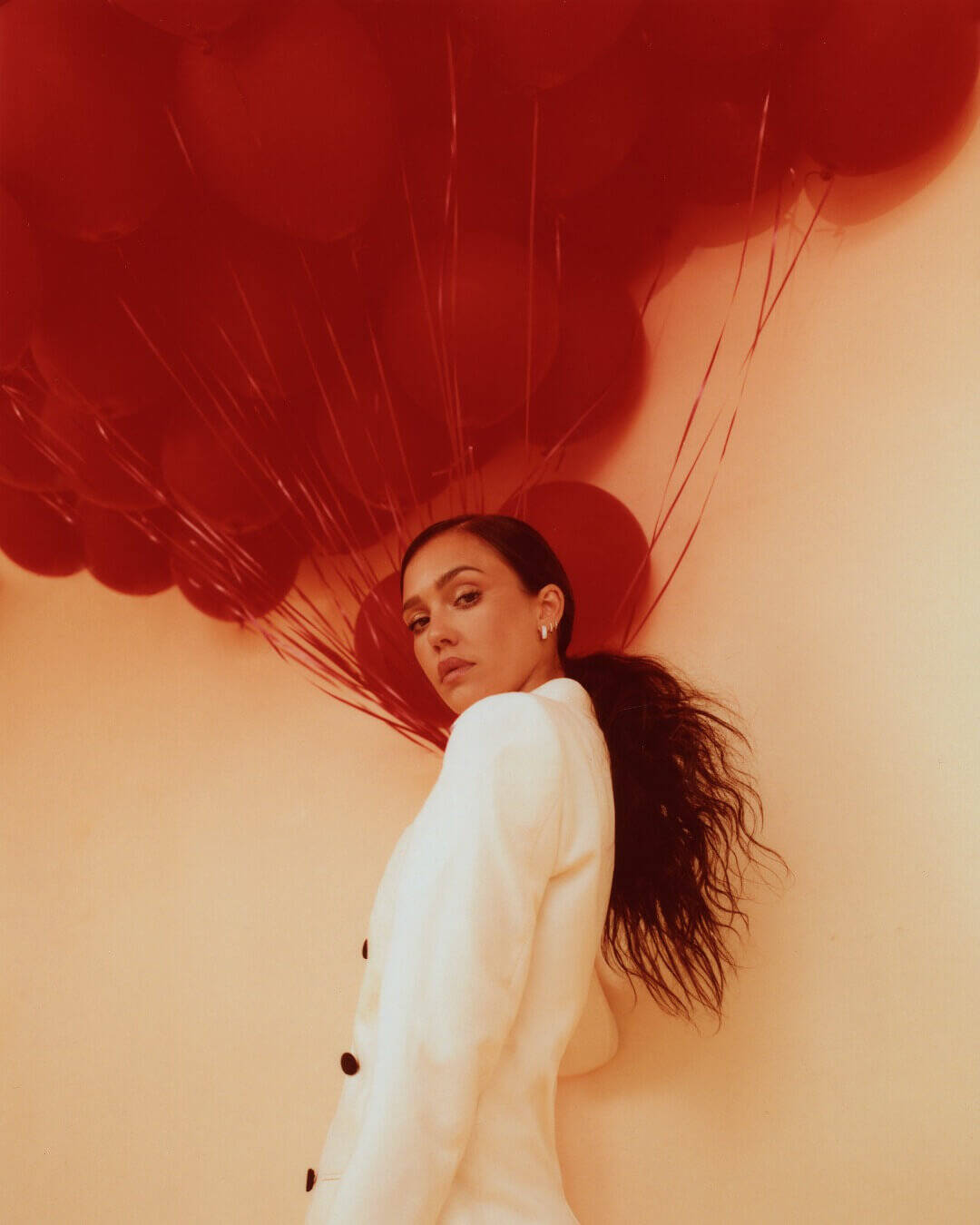 Actor Jessica Alba wearing a black-and-white Gucci jacket and pants with Ben Bridge earrings and rings