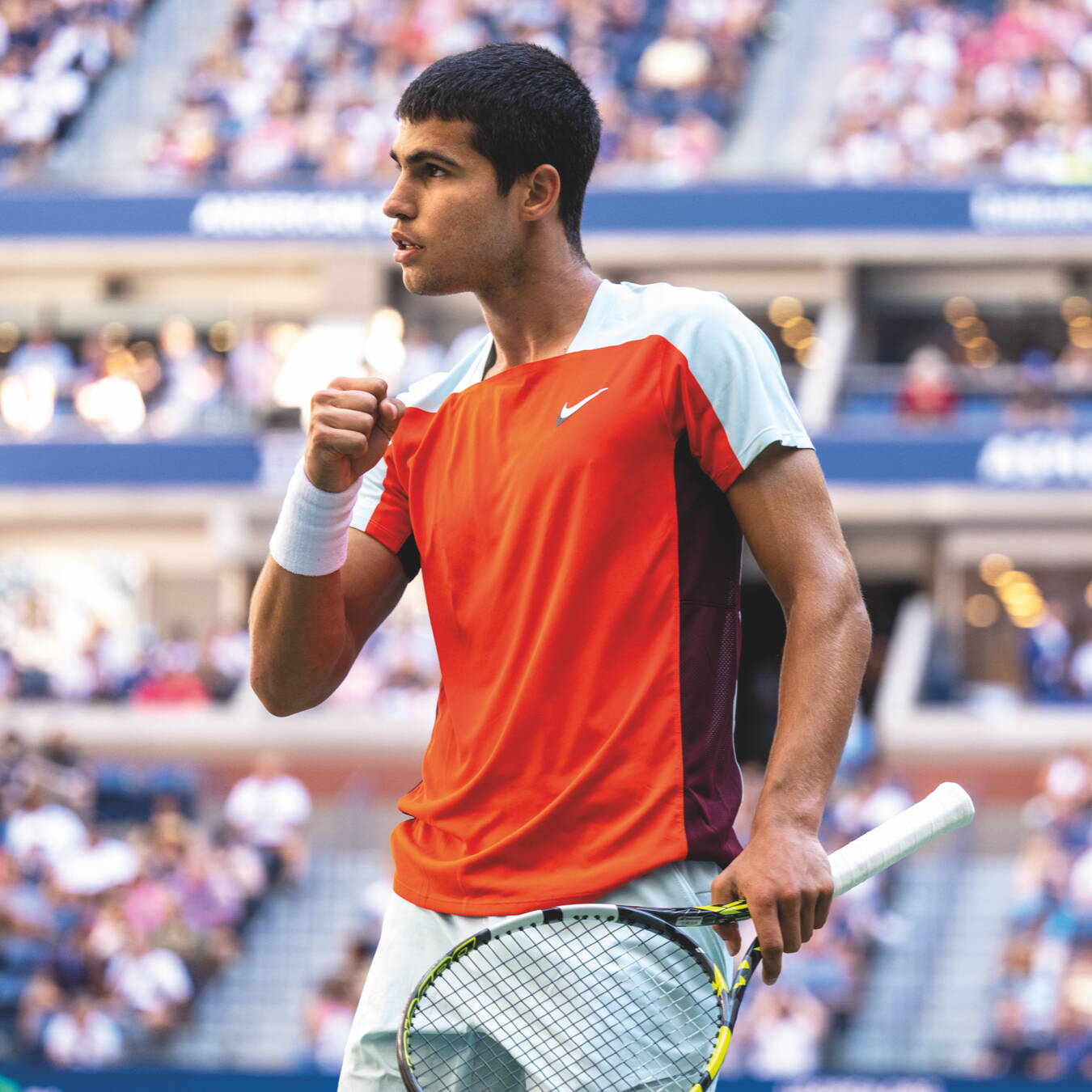 A world class tennis player pumps his fist in celebration at the US Open tennis tournament.