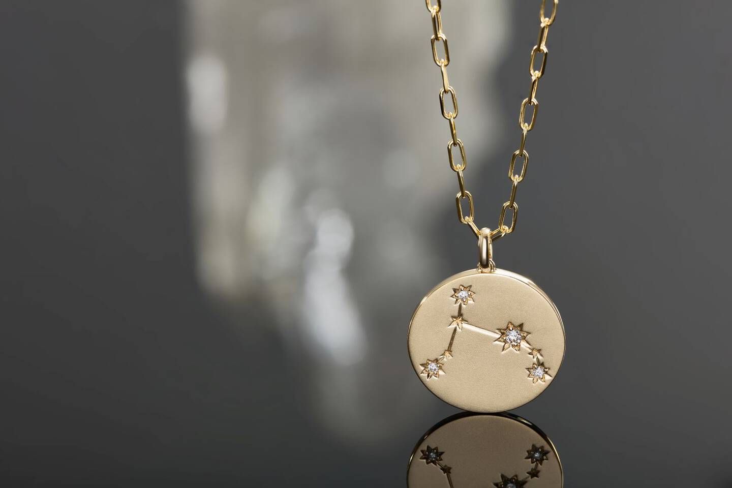 Diamond pendant showing a zodiac symbol. 