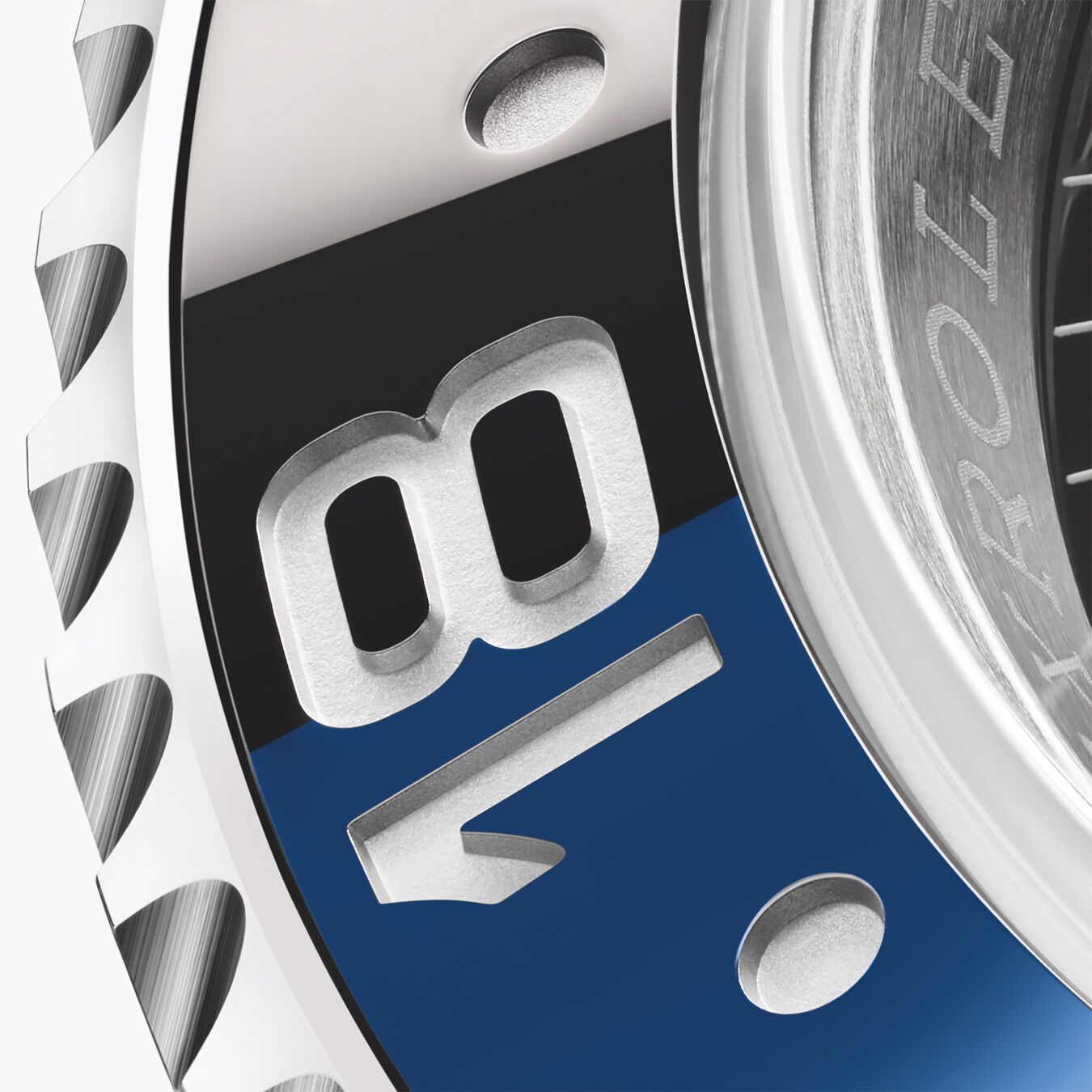 The 18 numeral marker of a blue and black Rolex ceramic bezel. 