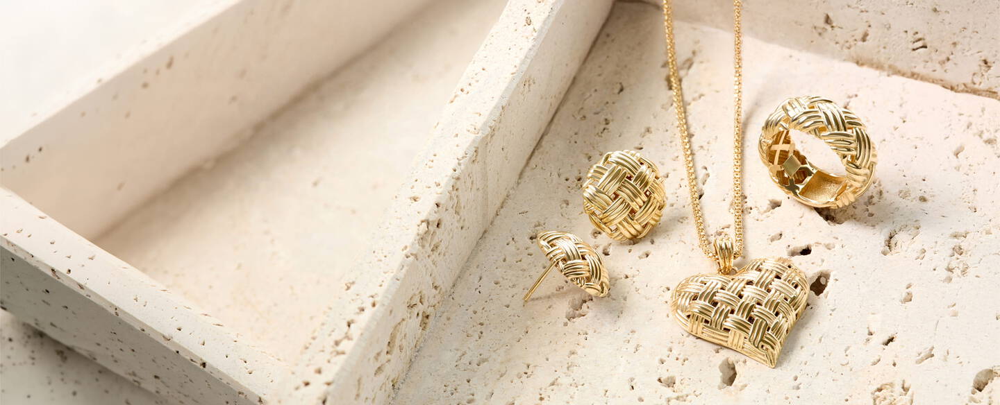 Yellow gold hoops, necklace and ring showcase exceptional artistry with a basket weave design and texture that captures the light.