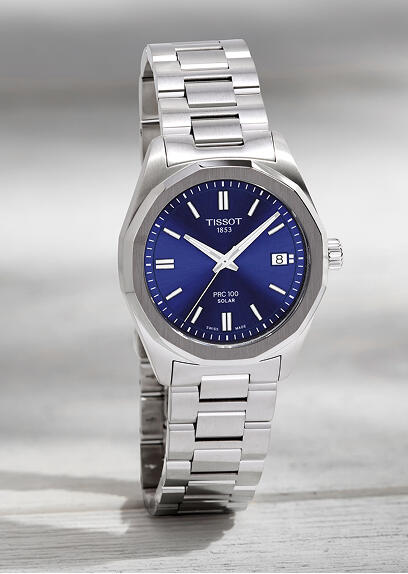 Tissot sports watch with a blue dial and stainless steel case.