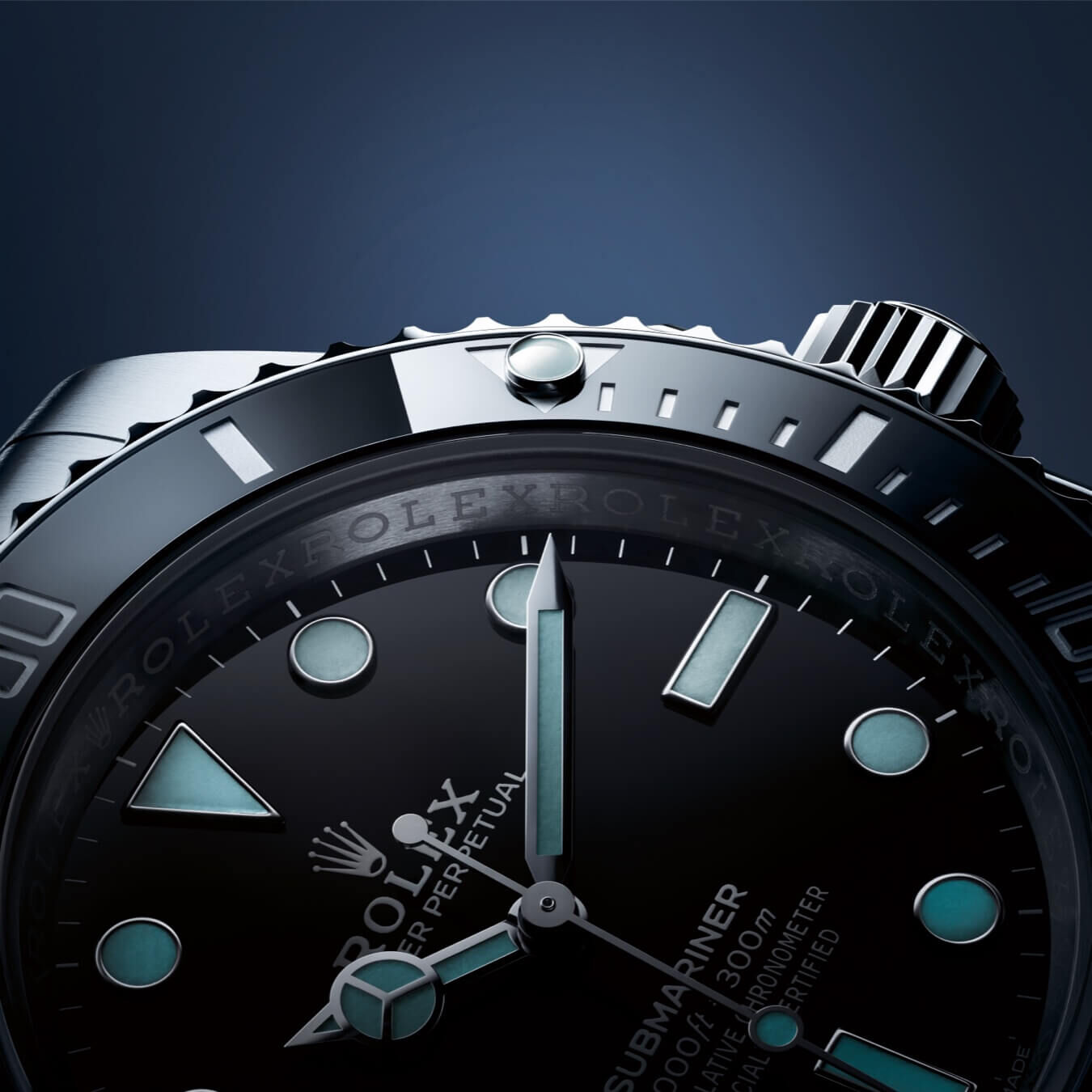 An Oyster Perpetual Submariner watch face with a black dial and insert in low light with slightly glowing luminescent hour markers and hands