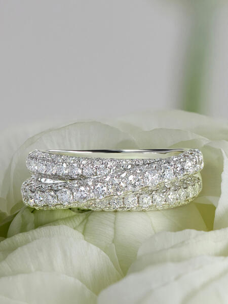 A diamond ring in white gold with overlapping bands.