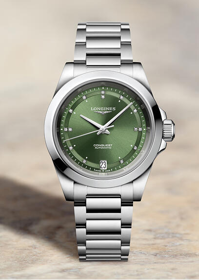 Stainless steel Longines sport watch with a green dial.