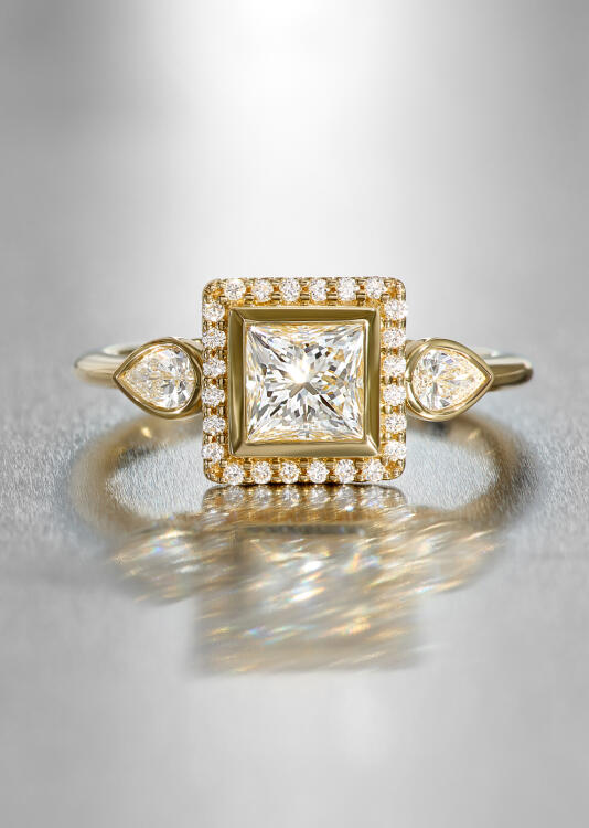 An engagement ring in yellow gold features natural diamonds in both classic and fancy shapes.