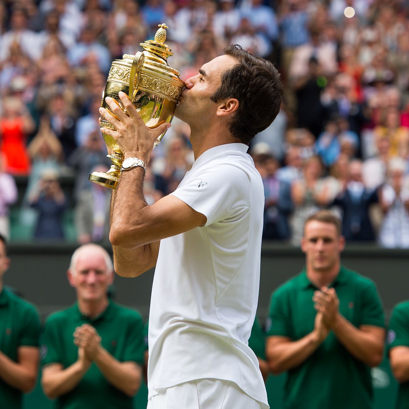 Wimbledon champion kisses his trophy.