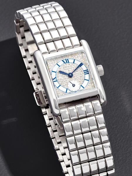 Classic luxury watch with stainless steel bracelet and white dial with blue indices.