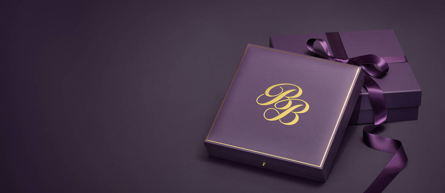 A purple gift box with gold lettering that shows the Ben Bridge Jeweler logo.