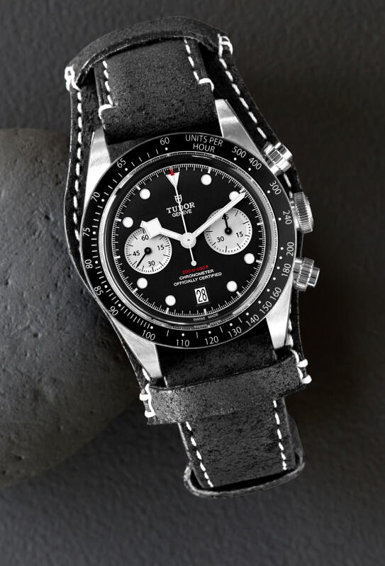 TUDOR watch with a black dial and black leather strap.