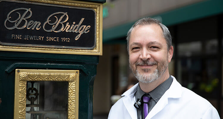 Watchmaker Next to Clock Outside Downtown Seattle Ben Bridge